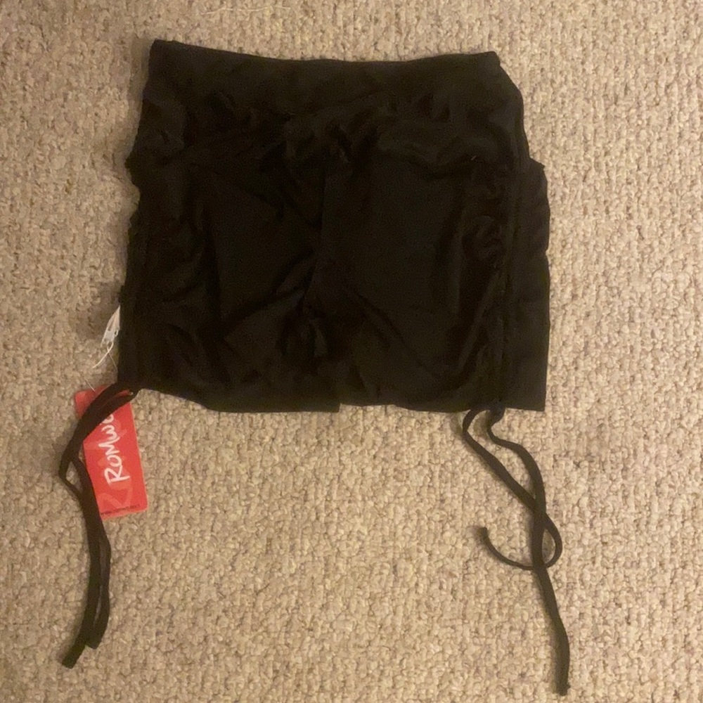 Black drawstring shorts on the side and cross over in the front of the shorts